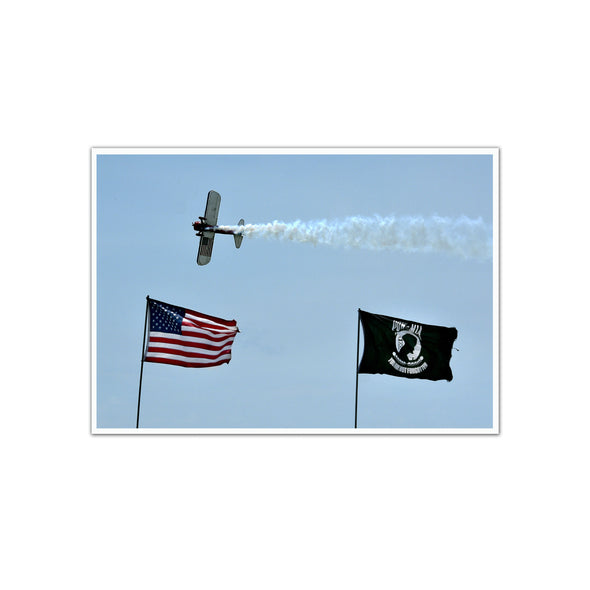 PT-17 Stearman Flying over US and POW/MIA Flags at Air Show, Unframed Print by Tom Gralish