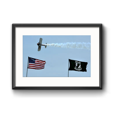 PT-17 Stearman Flying over US and POW/MIA Flags at Air Show, Framed Print with Mat by Tom Gralish