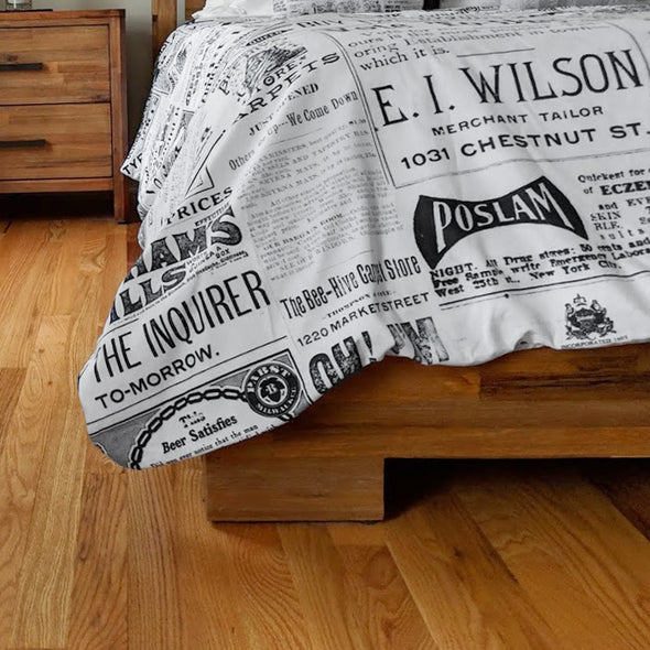 Close-up of Vintage Inquirer Ad Collage Duvet Cover on Bed in bedroom